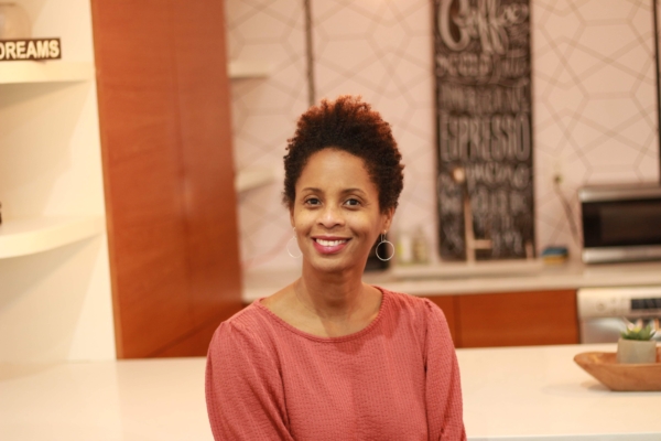 Kiva Slade sitting at a table with a smile.