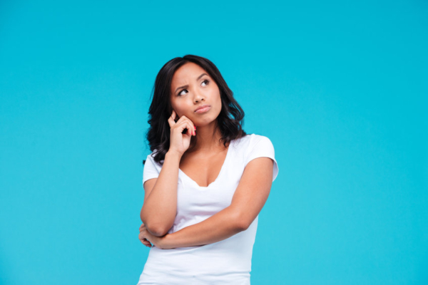 Portrait of a pensive pretty asian girl thinking about something