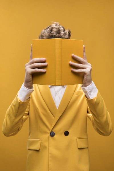 Young fashionable man reading a book